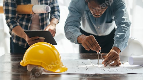 Preview: Close up view of Architect sketching a construction project on his plane project at site constructio