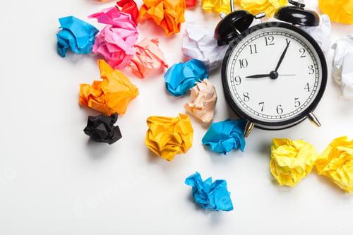 Preview: Alarm clock with crumpled paper balls.Timing and thinking idea concept