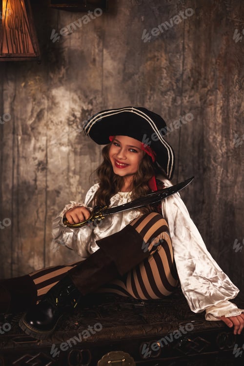 Preview: Laughing pirate with saber posing on chest in underground room or hold of pirates ship