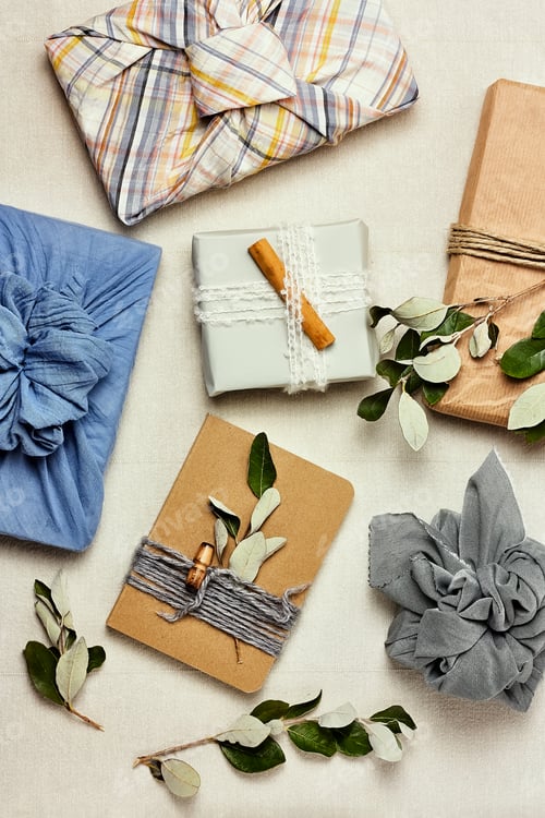 Preview: Trendy gift box wrapped in traditional Japanese furoshiki style on linen background.