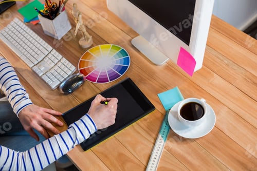 Preview: Designer working with colour wheel and digitizer in the office