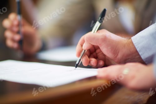 Preview: Businessman signing document in boardroom