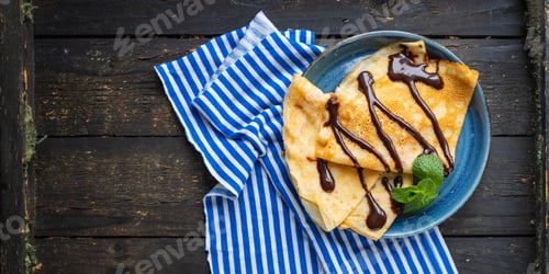 Preview: Crepes In A White Plate Thin Pancakes Pour Chocolate Syrup Flat Cake Shrovetide Snack Healthy Meal
