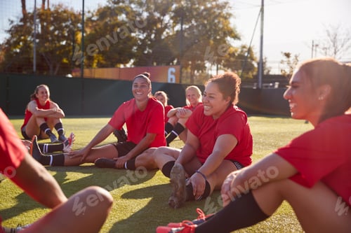Preview: Womens Football Team Stretching Whilst Training For Soccer Match On Outdoor Astro Turf Pitch