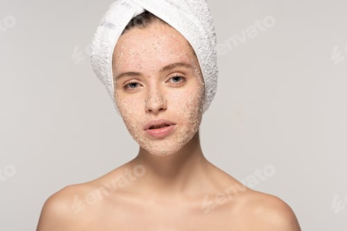 Preview: attractive girl with coconut scrub on face and towel on head, isolated on grey