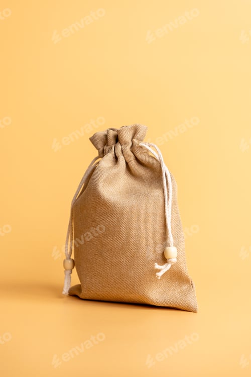 Preview: brown bag on an orange background. textile bag is made of natural material and has rope handle.