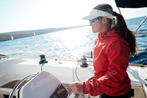 Preview: Attractive strong woman sailing with her boat