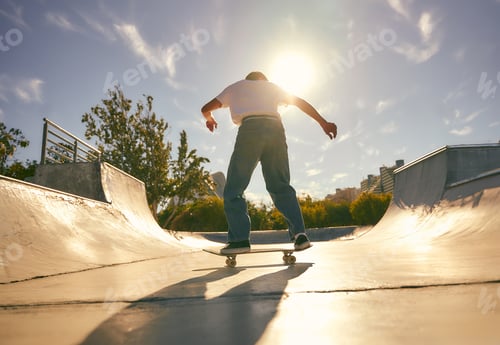 Preview: Back view of young skateboarder flies with his board on the ramp of a skate