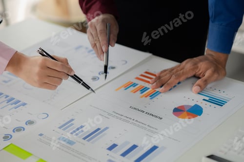 Preview: Business Professionals Reviewing Financial Charts and Graphs