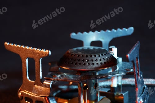 Preview: Closeup shot of a camping gas stove on a black background