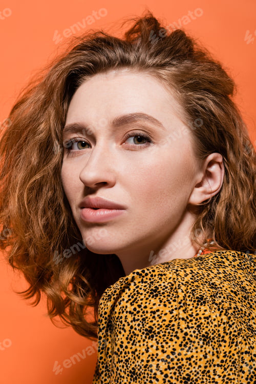 Preview: Portrait of stylish young red haired woman with natural makeup wearing yellow blouse and