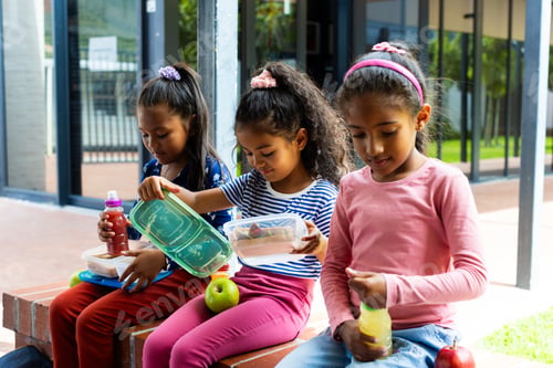 Preview: Three students share lunch, showing joy and diversity