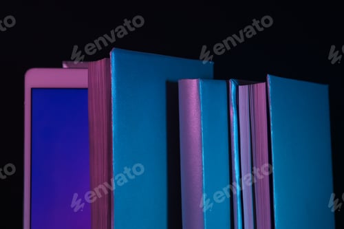 Preview: Books and tablet on black background, close up