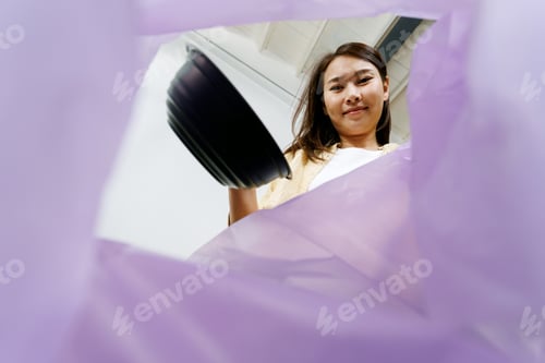 Preview: asian woman putting and sorting plastic food bowl waste to recycle bin POV.