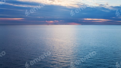 Preview: pink sunrise over calm blue Baltic Sea in autumn