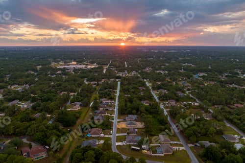 Preview: Aerial view of suburban landscape with private homes between green palm trees