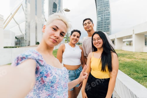 Preview: Group of multiethnic young friends outdoor taking selfie smiling having fun bonding