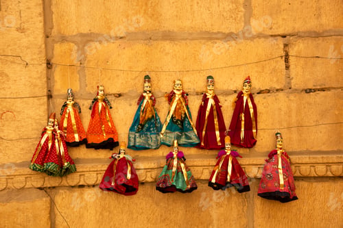 Preview: Colorful Rajasthani puppets hanging in the street of Jaisalmer, India.