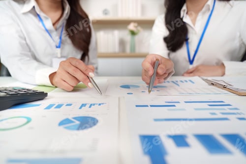 Preview: Data Collaboration. Professionals analyzing financial charts and graphs in a modern office.