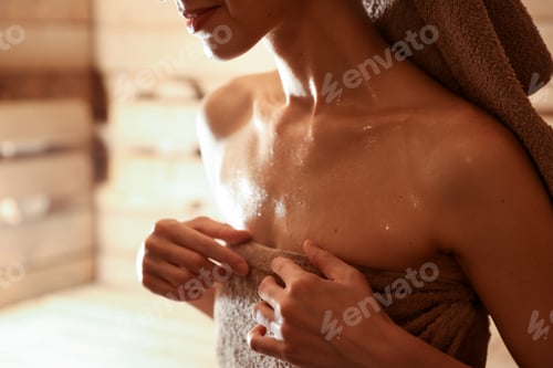 Preview: Beautiful woman in hot sauna, closeup. Space for text