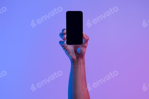 Preview: Social network and modern technology. Female hand holds phone with blank screen on neon background