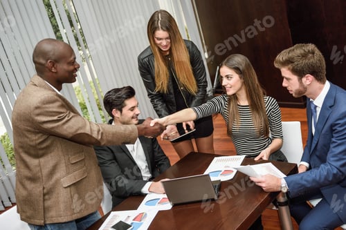 Preview: Business people shaking hands, finishing up a meeting