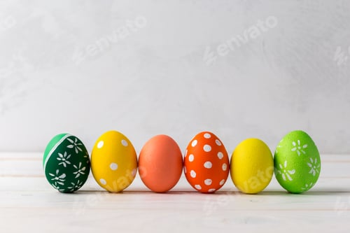 Preview: Colorful decorated eggs arranged in a row for a festive celebration