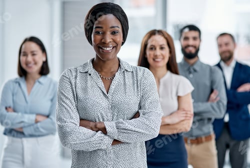 Vista previa: Portrait of a businesswoman standing in an office with her colleagues in the background