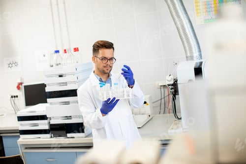 Preview: Handsome young researcher workin with chemical samples