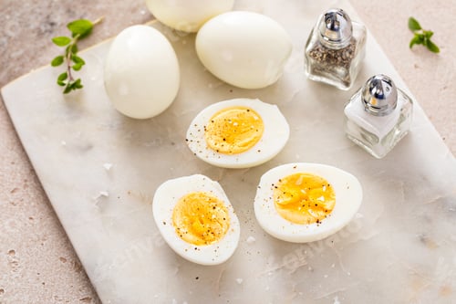 Preview: Boiled eggs peeled and cut in half with salt and pepper
