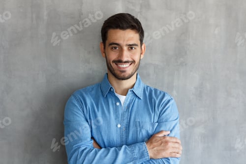 Preview: Young man standing with arms crossed in casual clothes, looking confident and optimistic