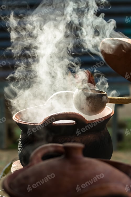 Preview: Handle spoon dipper over the smoke from traditional clay hot pot