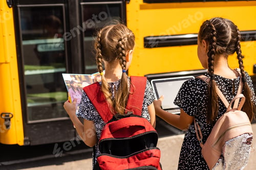 Preview: Education: Smiling Student Friends Ready For School next to school bus