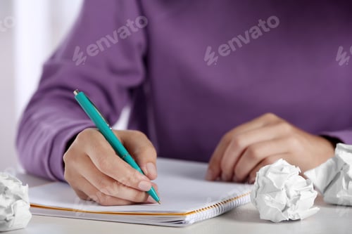 Preview: Woman working at table with crumpled paper, closeup. Generating idea