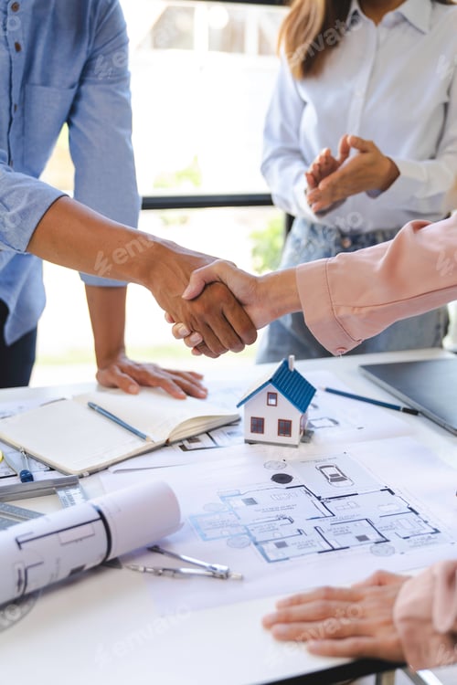 Preview: Architect and engineer construction workers shaking hands after successful collaboration. working si