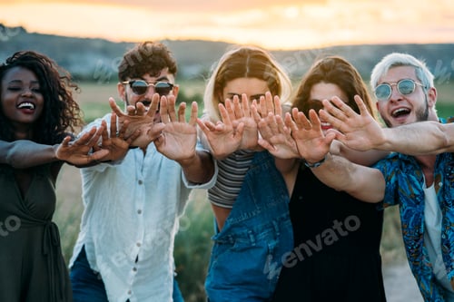 Preview: Young people reaching out hands in nature