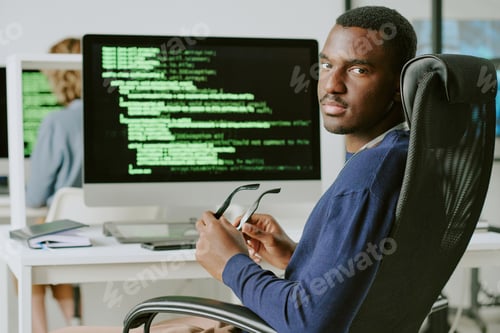 Preview: Young Black Cybersecurity Worker Looking At Camera