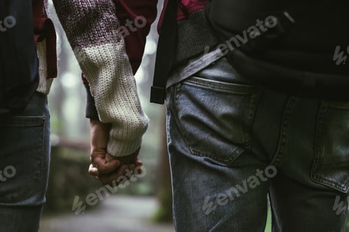Preview: Young couple traveler with backpack holding hand together