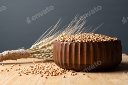 Preview: Wheat grain in the wooden bowl and wheat grain