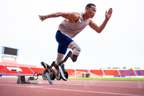 Preview: Asian para-athletes disabled with prosthetic blades running at stadium. A