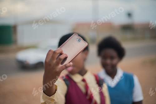 Preview: Two school girls taking a selfie, blurred background