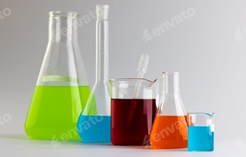 Preview: Close up of chemistry beakers and dishes with liquid and copy space on white background