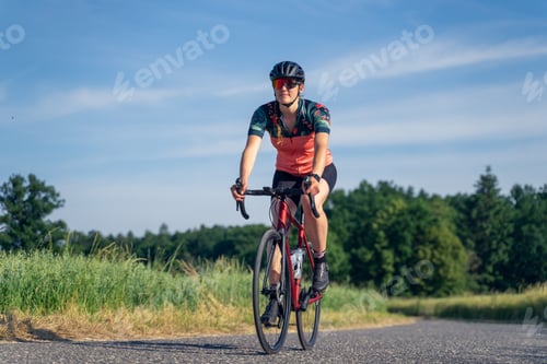 Preview: Angled photo, of a young woman professional cyclist