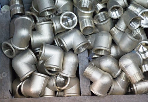 Preview: Closeup shot of iron pipe installation parts in a box