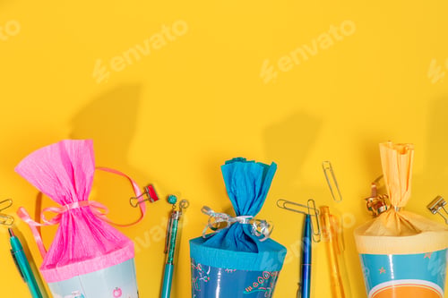 Preview: colorful School cones on yellow background for first day at school