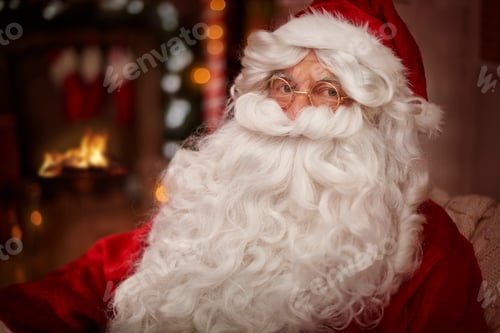 Preview: Santa claus warming up next to the fireplace