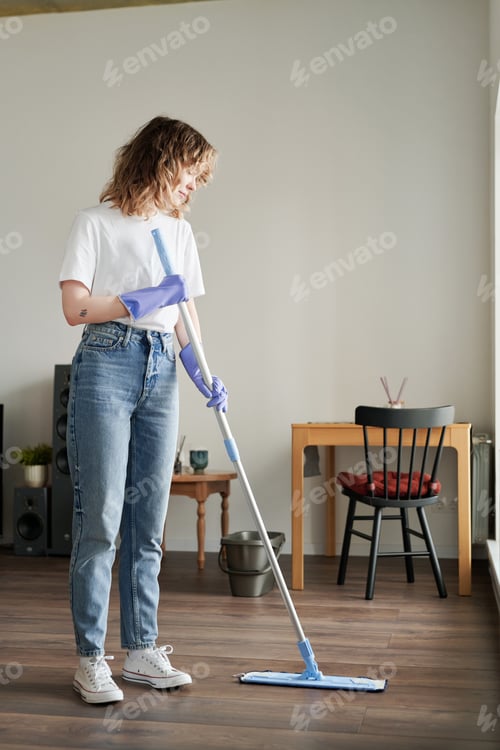 Preview: Housewife wiping the floor at home