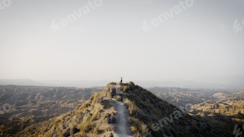 Preview: Muslim woman achieving freedom on desert mountain top