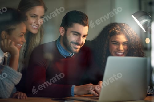 Preview: Shot of a group of young entrepreneurs working late on a laptop in an office