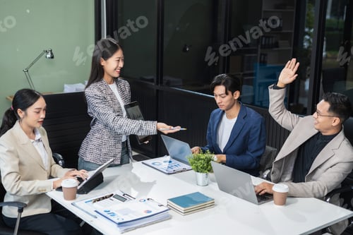 Preview: businessman with laptop, tablet pc computer and papers having discussion in modern office.